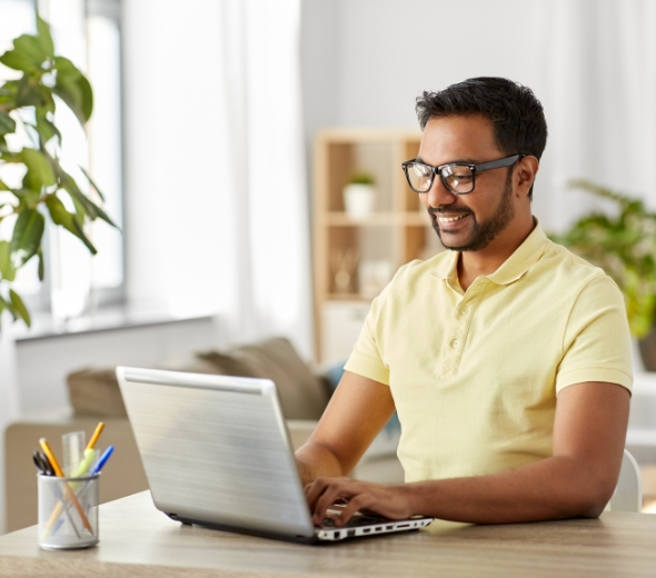 Indian man working on laptop